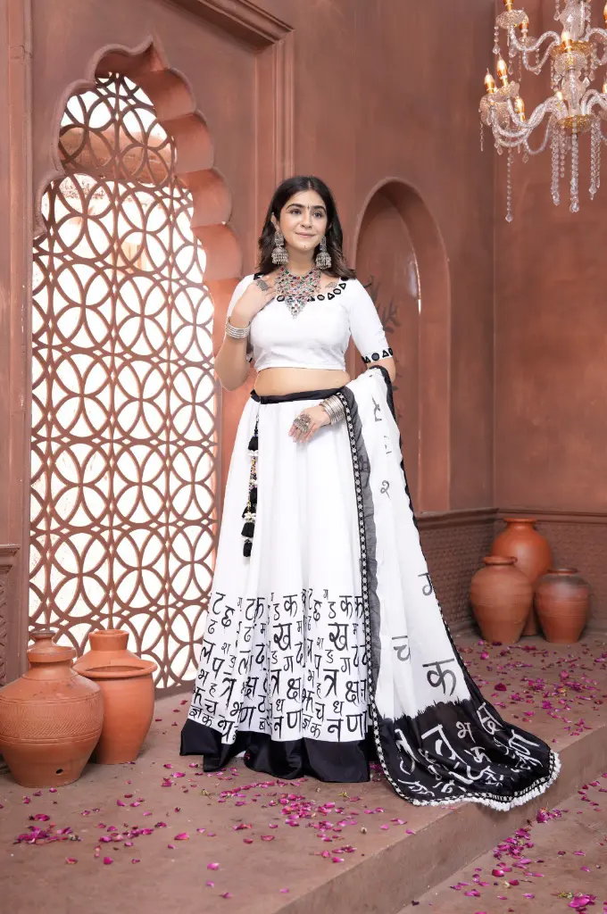Peace white lehnga-choli with Hindi scriptures printed and mirror work on blouse 