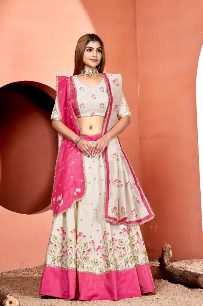 Off-white and pink lehnga-choli with muslin shimmer fabric and lace embellishment on printed kali and flare