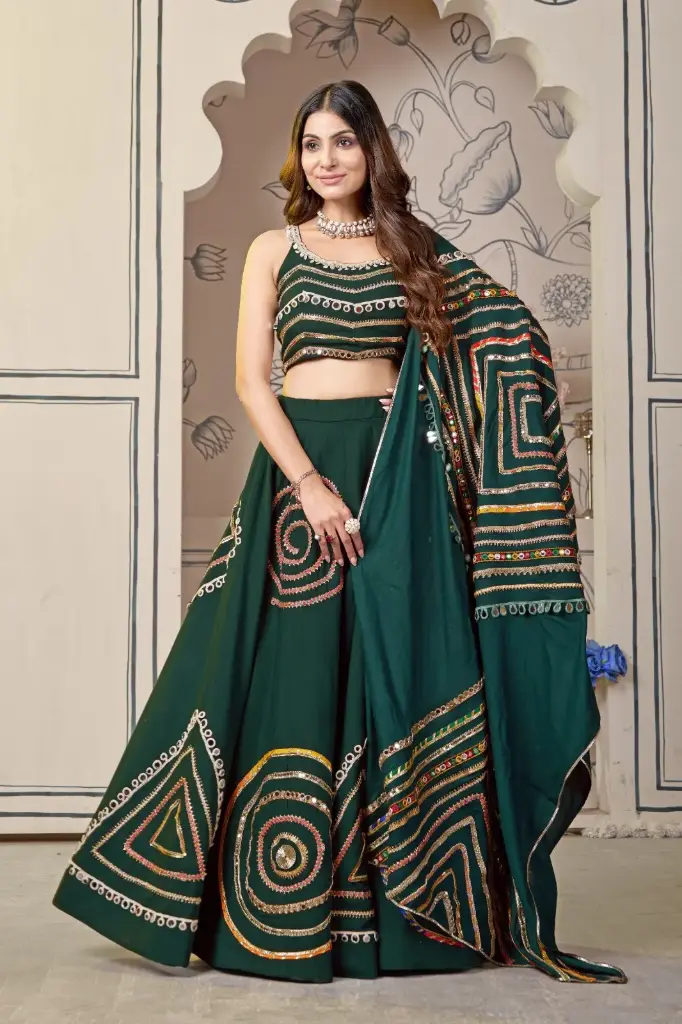 Green lehnga-choli with intricate lace and mirror working in Rajasthani style